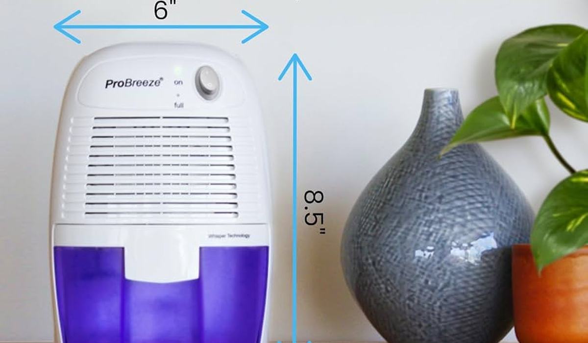 Compact dehumidifier with capacity markings in a small apartment