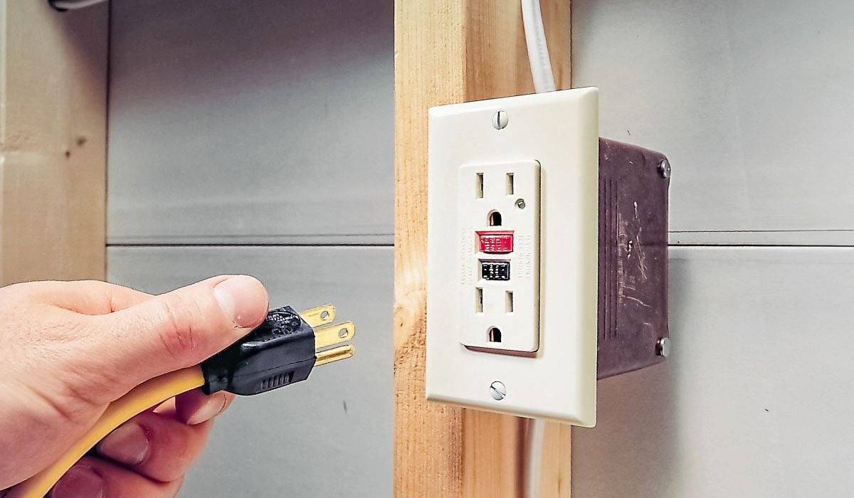 Non-contact voltage tester checking a wire